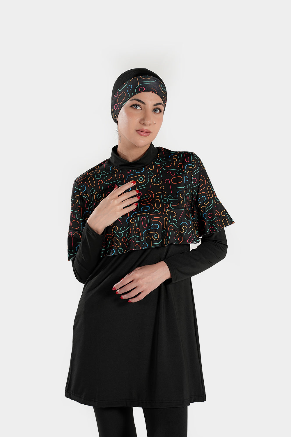 Four-piece BAE Modest printed burkini set with long sleeves, ruffles, pleats, and flexible fabric for modest active swimming.