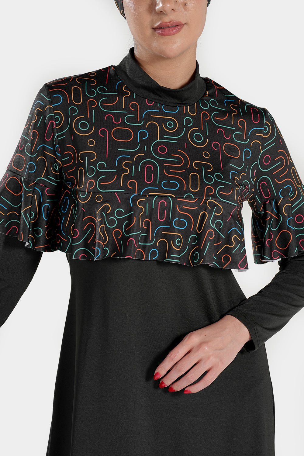 Printed design BAE Modest 4-piece long sleeve burkini with ruffles and pleats, flexible modest active swimwear in a vibrant pattern.