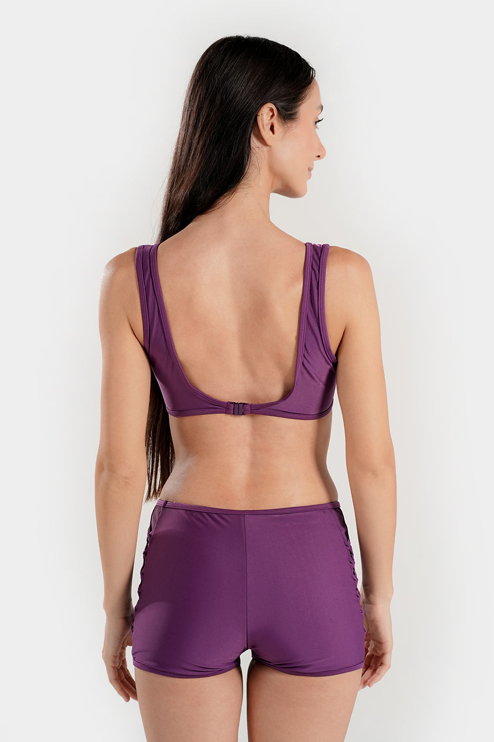 Women’s high-waisted bikini set with lattice mesh detail and sporty shorts, by BAE Modest. Blue and black swimwear on a model.