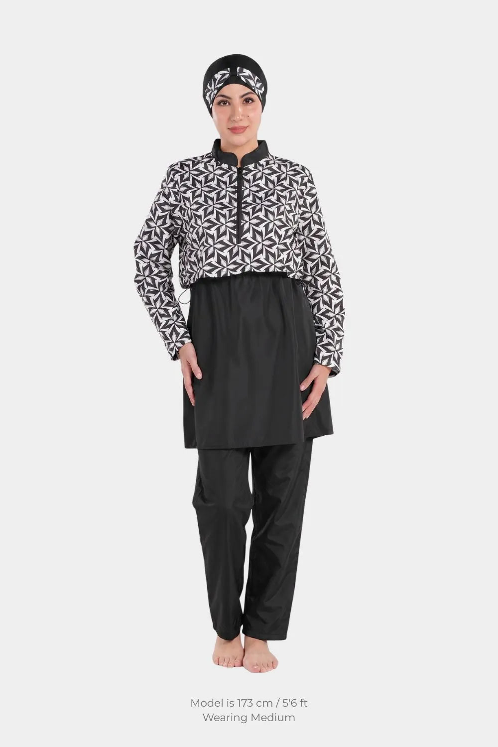 Monochrome leaf print modest swimwear set by BAE Modest, featuring a waterproof 3-piece swimsuit with a long-sleeve top, pants, and hijab.