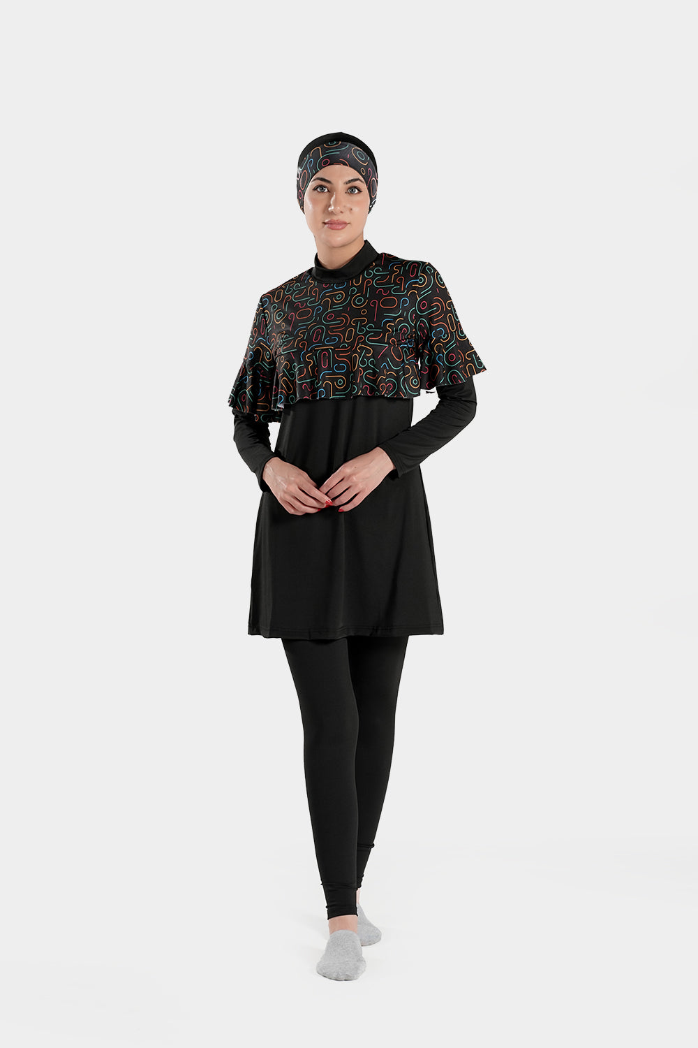 Four-piece BAE Modest burkini set with printed design, long sleeves, ruffles, pleats, and flexible fabric for modest active swimwear.
