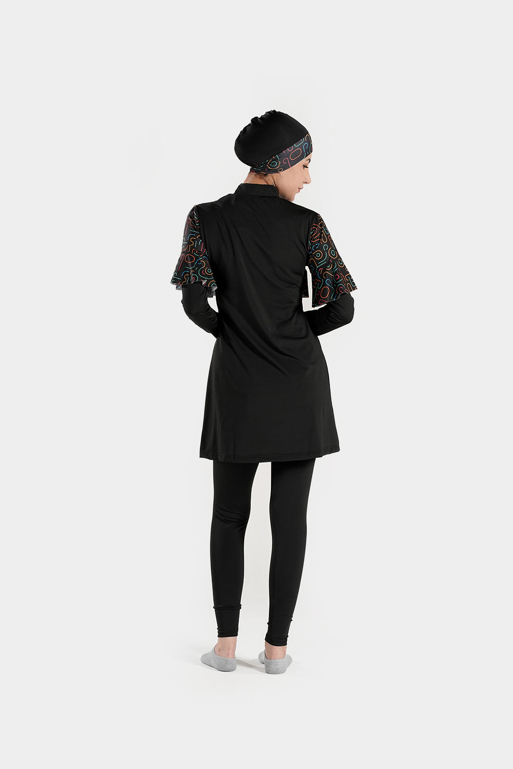 Four-piece BAE Modest burkini set with printed long sleeve top, pleated skirt, and ruffled accents for modest active swimming.