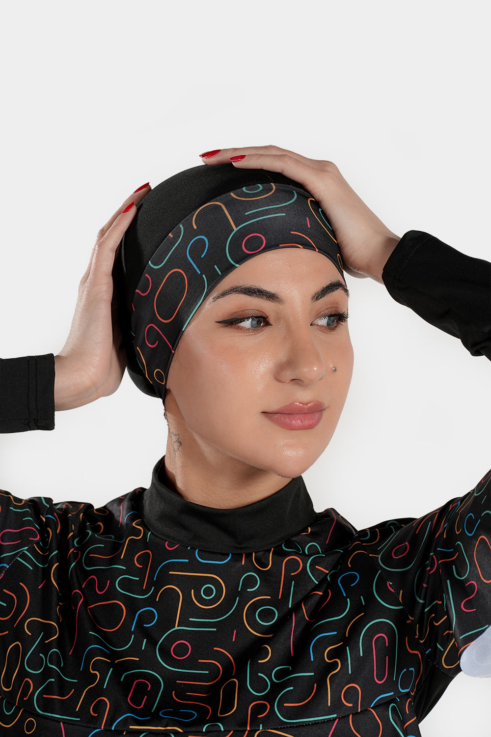 Four-piece BAE Modest printed burkini set with long sleeves, ruffles, pleats, and flexible fabric for modest active swimming.