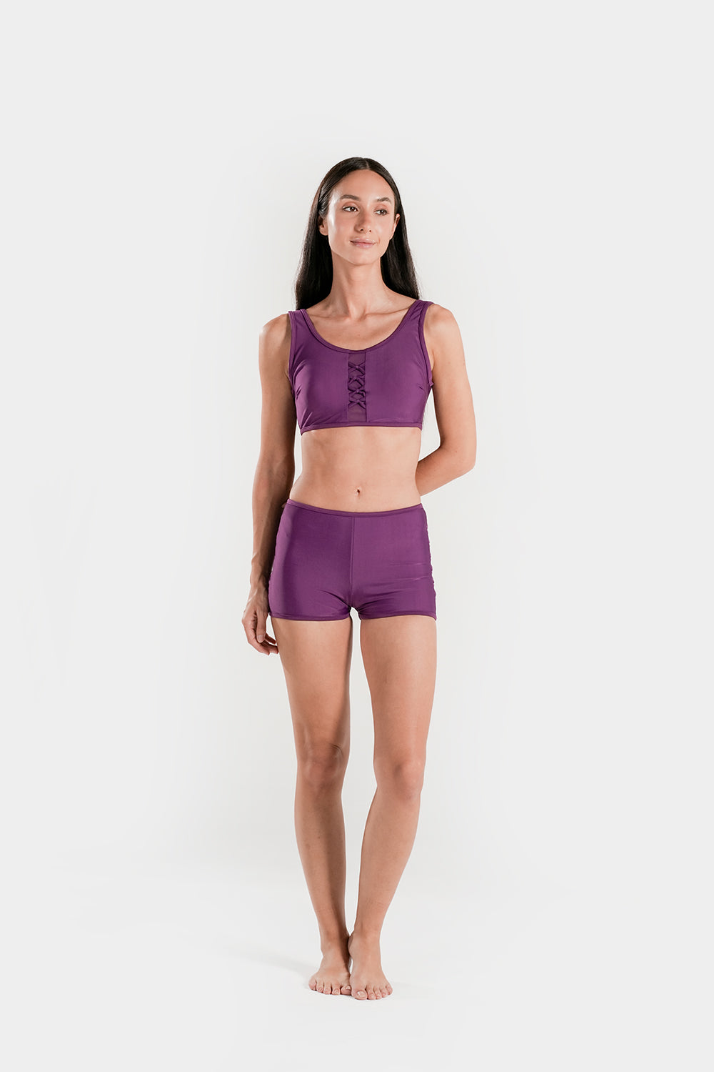 Women’s high-waisted bikini set by BAE Modest with lattice mesh details and sporty shorts, shown on a model.