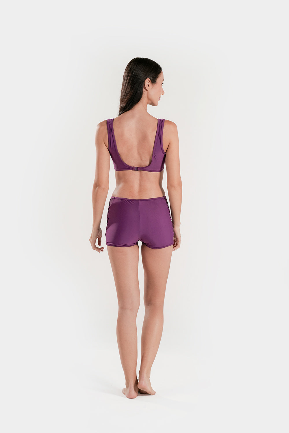 Women’s high-waisted bikini set with lattice mesh detail and sporty shorts by BAE Modest, shown on a model.