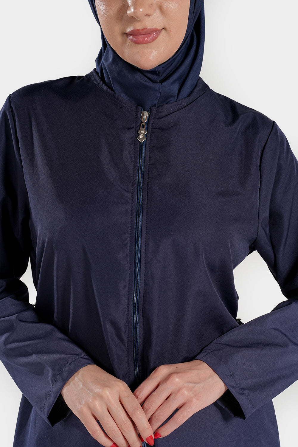 BAE Modest women's mid-length full sleeves solid color burkini with hijab for modest swimwear, shown on a model in a pool setting.